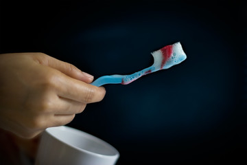 toothbrush with scurvy in a bubble toothpaste on the dark background