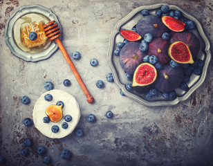 Fresh figs of different varieties, on metal plates.Toned image. Vintage style.Copy space.selective focus