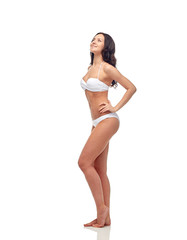 Fototapeta premium happy young woman in white bikini swimsuit