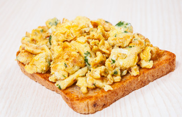 Scrambled eggs on toasted bread.