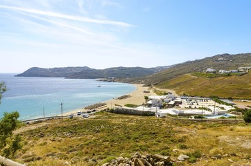 Aerial view of Elia beach on greek island Mykonos, Greece. A view of the blue sea, sunbeds, sun...