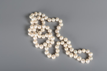 pearl necklace on gray background