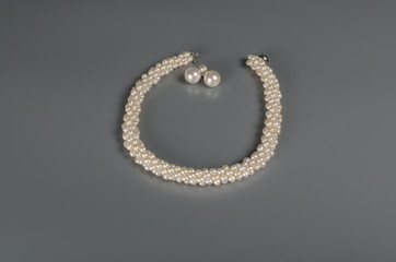 pearl necklace on gray background