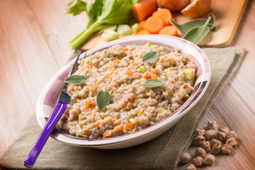 barley risotto with chickpeas and vegetables, selective focus