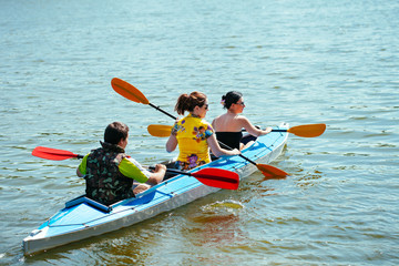 Young people in canoes. Family holiday.