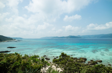 Fototapeta premium Tropical paradise island beach lagoon and white sand beach full of beautiful clear blue turquoise water in Amami Oshima, Kagoshima, Okinawa, Tropical Japan during Summer vacation