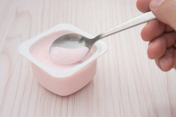 eating strawberry flavor yogurt