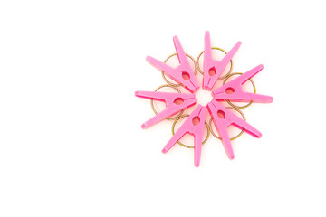 pink clothespins line up as a circle on a white background