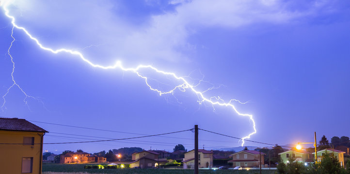 Lightning strike hitting neighborhood in Tuscany, italy. Powerful lightning.