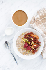 oatmeal with baked fruit and coffee with milk, top view vertical
