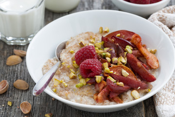 oatmeal with baked fruit and pistachios for breakfast, closeup