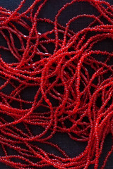 close up of red pearls on black background