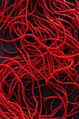 close up of red pearls on black background