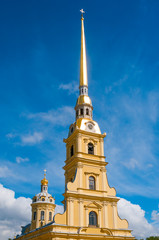 Spire of Peter and Paul Fortress against blue sky in St. Petersburg, Russia