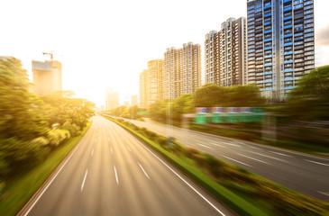 empty asphalt road in modern city under twilight