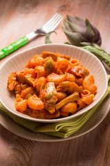 pasta with artichoke and tomatoes sauce, selective focus