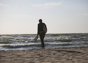 Fototapeta na wymiar woman walking by sea shore