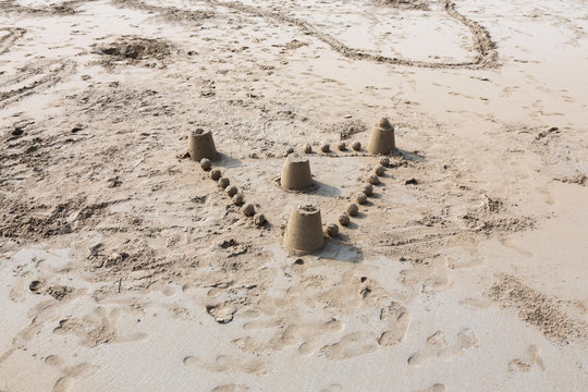 The sandy beach of the Atlantic Ocean. South of France. Basque Country. Hendaye. Blue sky with high clouds and yellow sand. horizon line in the middle. space for inscriptions. sand castle