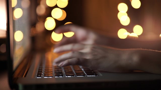 Female hands typing on a laptop keyboard for Christmas