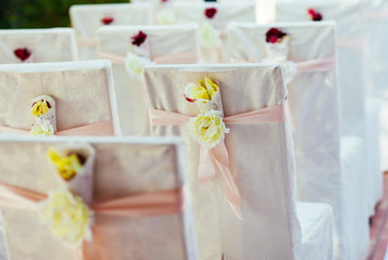 Wedding ceremony chairs. Floral arrangement at a wedding ceremon