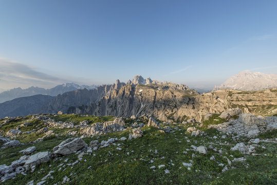 Mountains Panorama of the Dolomites at Sunrise with flowers in f