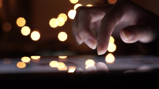 Closeup Finger Touching Tablet Computer Touchscreen on christmas