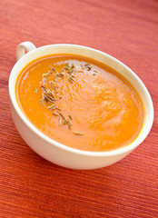 Vegetarian carrot-pumpkin cream soup with garlic and cumin