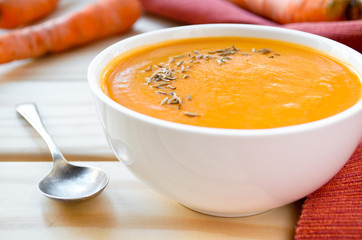Vegetarian carrot-pumpkin cream soup with garlic and cumin
