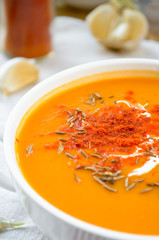 Vegetarian carrot-pumpkin cream soup with garlic and cumin