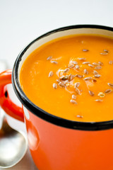 Vegetarian carrot-pumpkin cream soup with flax seeds