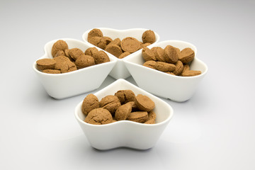 Four dishes formed as a clover four filled with kruidnoten