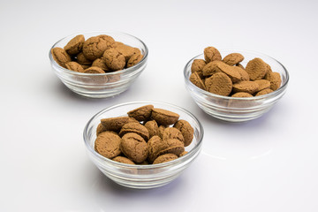 Three dishes of glass filed with pepernoten and kruidnoten