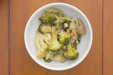 stir fried vegetable in white bowl on wooden table