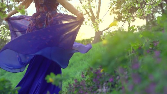 Beauty girl in blowing long transparent chiffon dress.  Enjoying nature outdoor