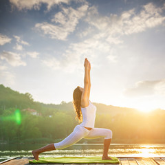 Woman doing yoga on the lake - beautiful lights - 92947837