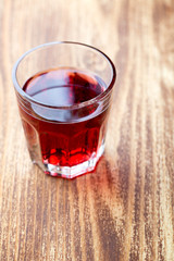 Single glass with red drink