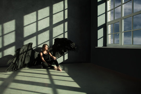 Black Angel looking out the window. Freedom Concept
