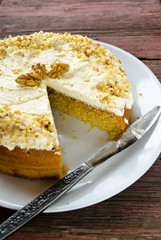 Homemade cake with butter cream and walnuts