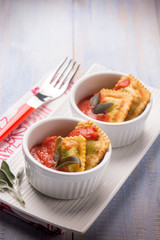 fried ravioli with tomatoes sauce, selective focus