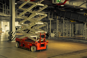 warehouse hall with hydraulic scissors lift