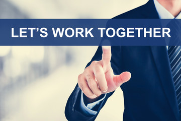 Businessman hand touching LET'S WORK TOGETHER message on virtual
