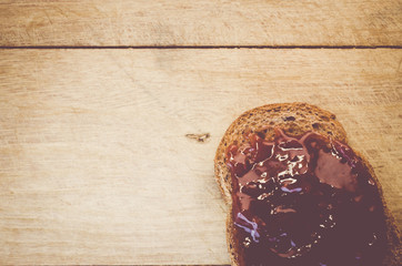 crisp bread with jam on a natural wood background