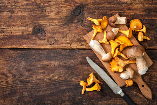 Porcini and chanterelle mushrooms on a cutting board