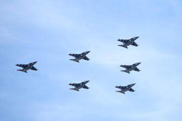 Fototapeta na wymiar Six Russian military trainer subsonic attack planes SU-25 UTG Rook in flight against the blue sky on parade on May 9, 2015 in Moscow Russia