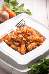 pasta with tomatoes sauce and bacon, selective focus