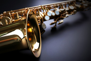 Golden saxophone on dark background