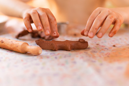 Child making a clay figure