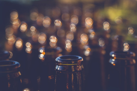 Full frame abstract close-up of Rows of open beer bottles