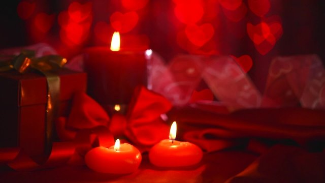 Valentine's Day. Beautiful Valentine scene with red hearts candles.