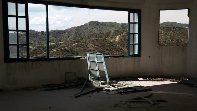 Beautiful landscape out of wide window of an abandoned hotel